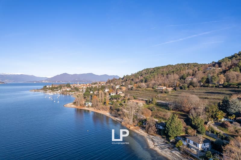 Coastline with houses, sea, mountain range, vineyard