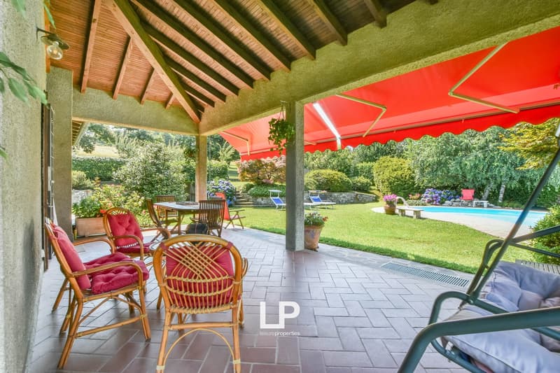wooden patio, awning, outdoor dining table, swimming pool, garden, swing