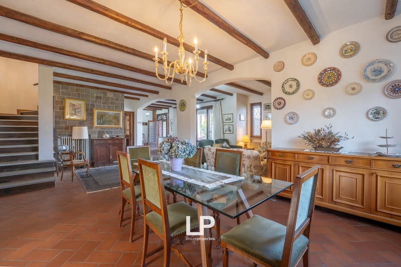 dining room with wooden ceiling, chandelier, dining table, chairs, wooden cabinet, wall with plates, staircase