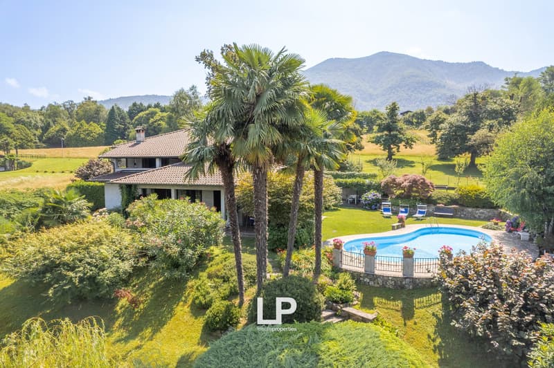 Single family home with pool, greenery, mountain view, palm trees, garden