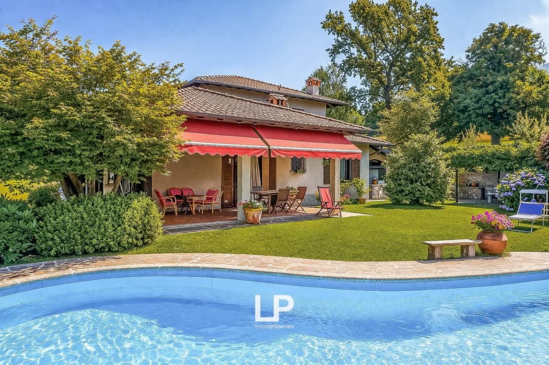 Detached house, red awning, outdoor dining area, swimming pool, garden, trees