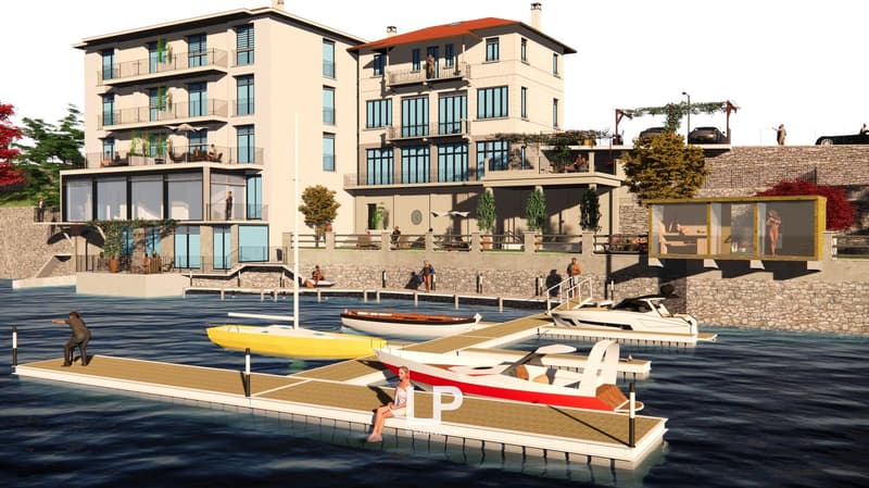 residential building, water front, 2 boat docks, multiple floors, balconies, cars parked on roof
