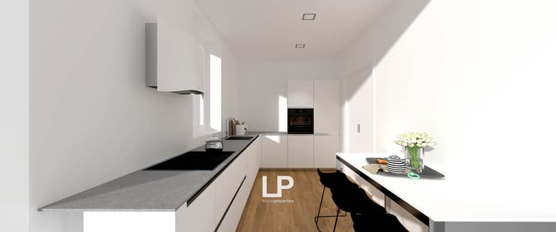 Modern kitchen with black counters, white cabinets, built-in appliances, and wooden floor