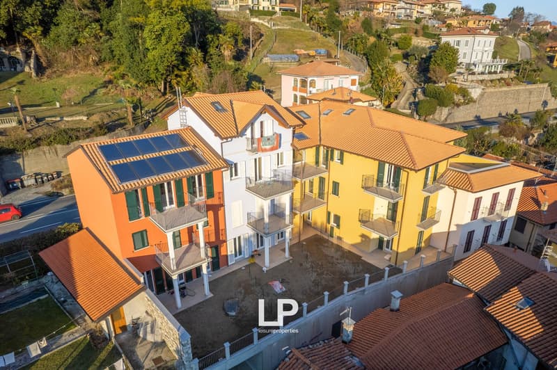 multiple houses with multiple floors and balconies, solar panels on one house