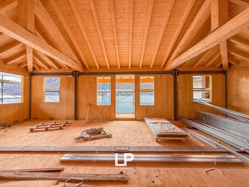 unfinished room, wooden walls, wooden floor, open doors, construction materials, windows with views