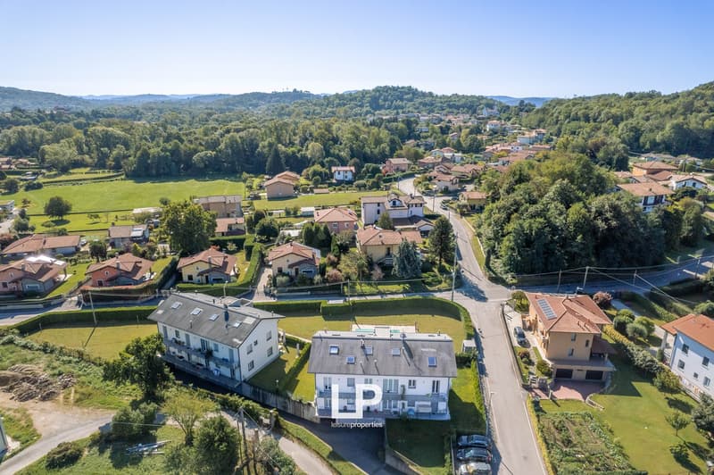 Aerial view of residential neighborhood with multiple houses, one having solar panels