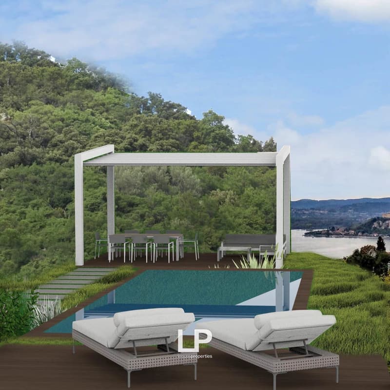 The image shows an outdoor living area with a covered patio, a swimming pool, and a scenic view of the surrounding landscape. The patio has a modern, minimalist design with white metal frames and seating. The pool is located in front of the patio, and the