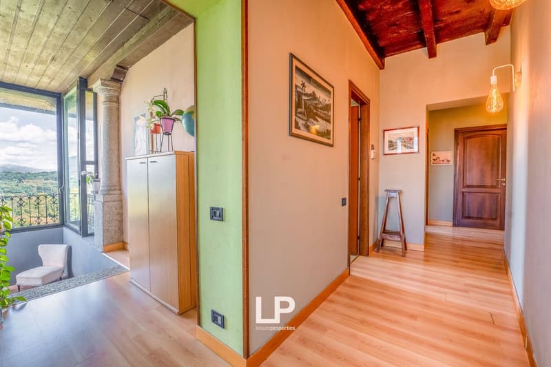 wood floor, wall painting, window, cabinet, balcony, plants, chair, stool, door, wall light, picture frame
