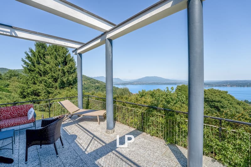 terrace with railings, cushioned furniture, table, panoramic view, large trees