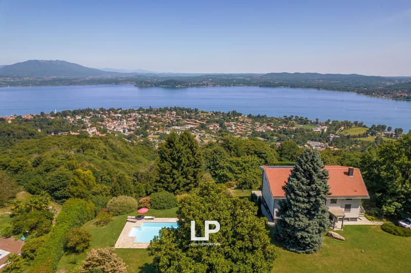 House with red roof, swimming pool, scenic view, mountains in the distance