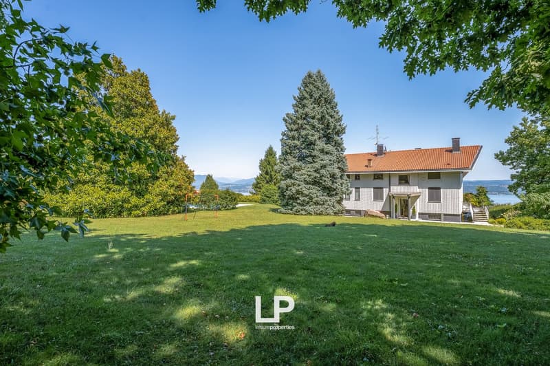 2 story house, red roof, large yard, large windows, mountain view
