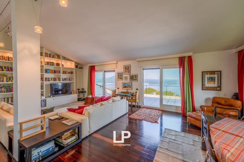 sofa, armchairs, coffee table, bookshelves, tv, window with balcony