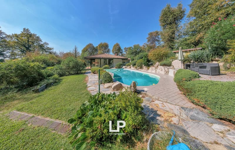 House, swimming pool, garden, large trees, plants, rocks, pathway, sitting area