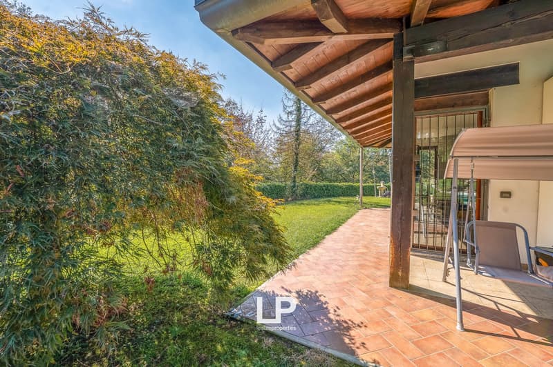 tiled terrace, wooden awning, swing, garden, hedge