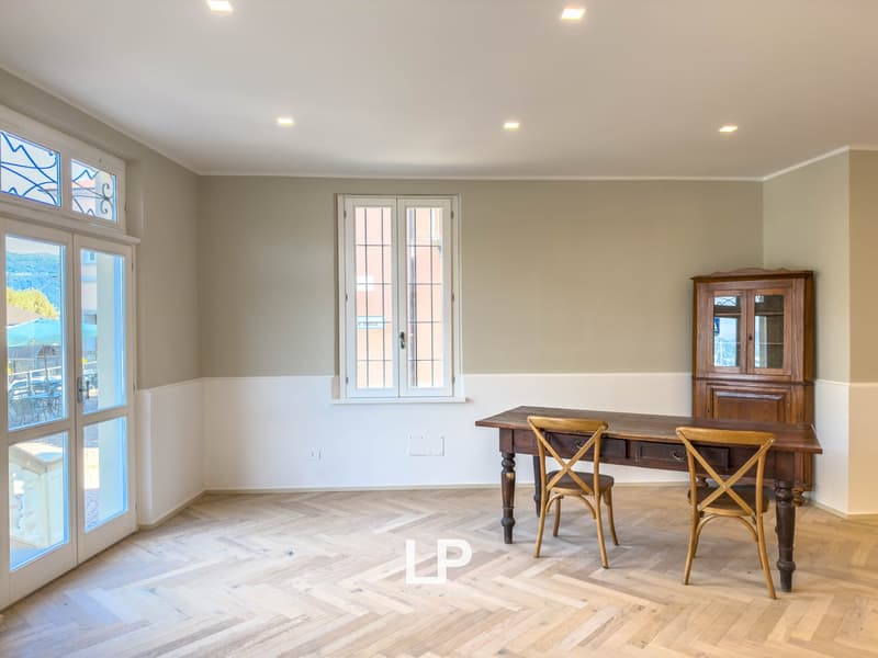 Wooden table and chairs, parquet flooring, French doors, tall windows with wooden frame