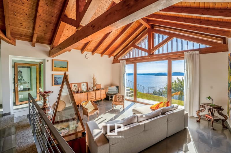 open living space, glass wall, wooden ceiling, sofa, sea view
