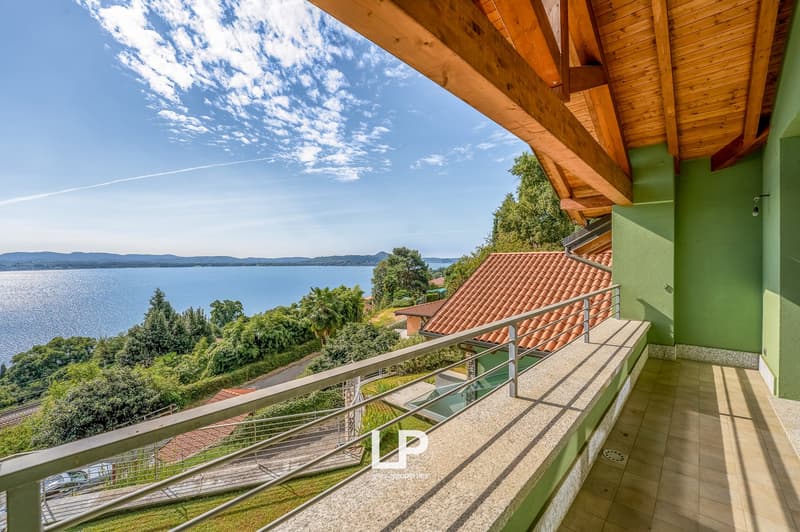 Wooden balcony with railings, wooden roof, breathtaking lake view