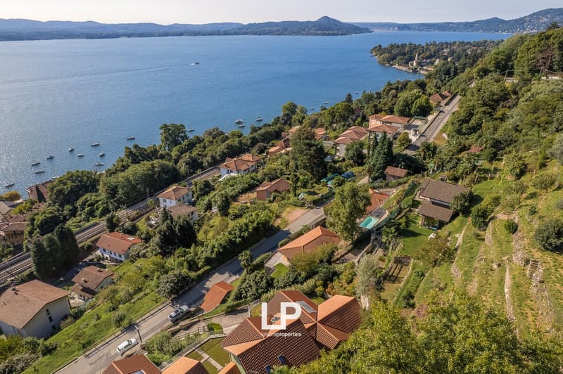 houses along the lake, hills, trees, road