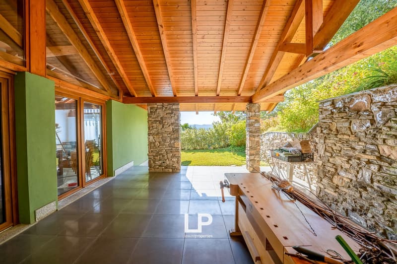 Wooden roof, green walls, tiled floor, open space, wooden table, garden view