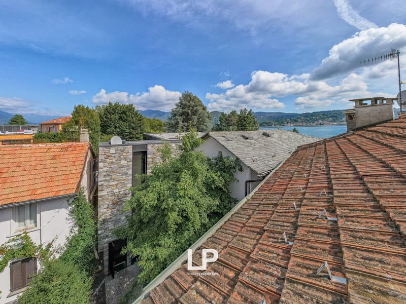 Terraced houses, tiled roofs, surrounding greenery, mountain and lake view