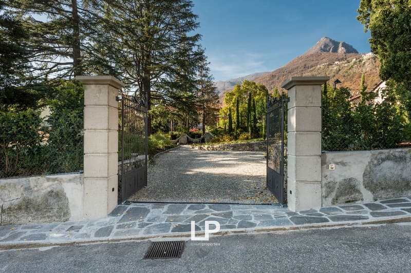 gated driveway leading to a villa