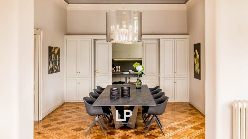 wooden parquet floor, long table, large white cabinets, large chandelier, flower vase, paintings