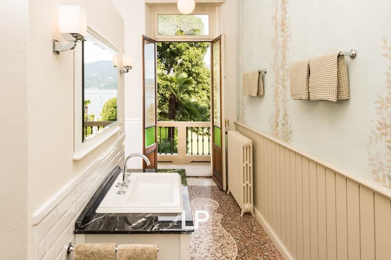 Sink, mirror, radiator, tiled floor, towels, balcony view