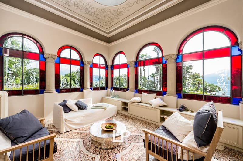 arched stained glass windows, decorative pillows, round table, floral arrangements, ornate ceilings, marble floors