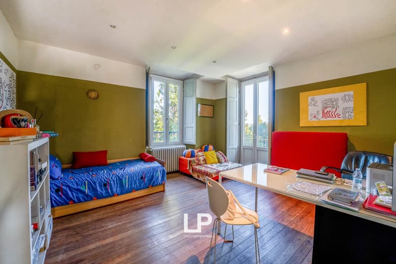 wooden floor, beds, study table, chair, couch, painting, shelves, radiator