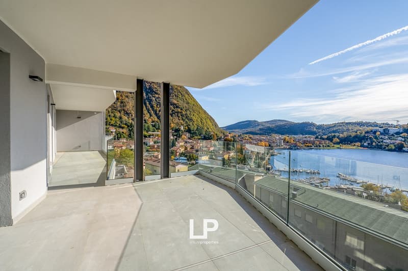 Large glass railing, stunning mountain and lake view, tile floor, outdoor lighting