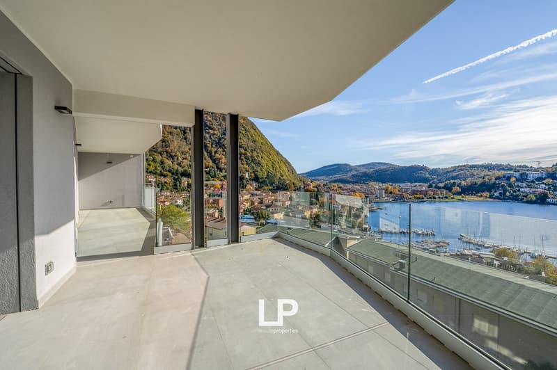 modern terrace with glass railing, stunning views of mountains and lake, polished tile floor, minimalistic design