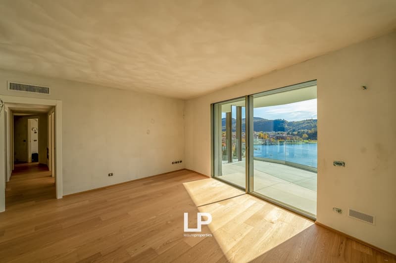 wood floor, large sliding doors to balcony with lake view
