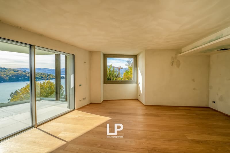 open floor plan, hardwood floors, sliding doors, balcony, lake view