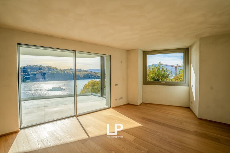 wooden floors, double sliding glass doors, large windows, terrace, balcony with railings, view of the lake