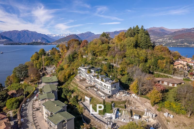 newly built houses with lake view, mountainous landscape, lake, trees, hills, and mountains in the background