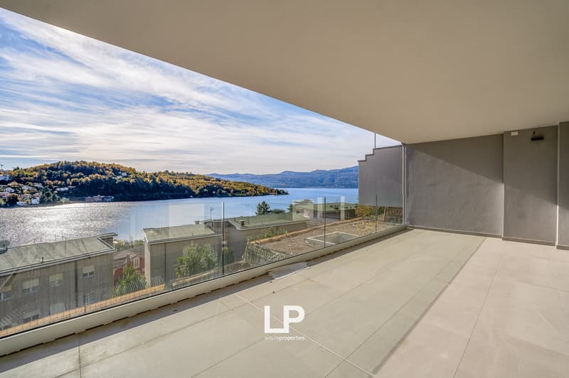 Modern terrace with a sea view, surrounded by glass panels