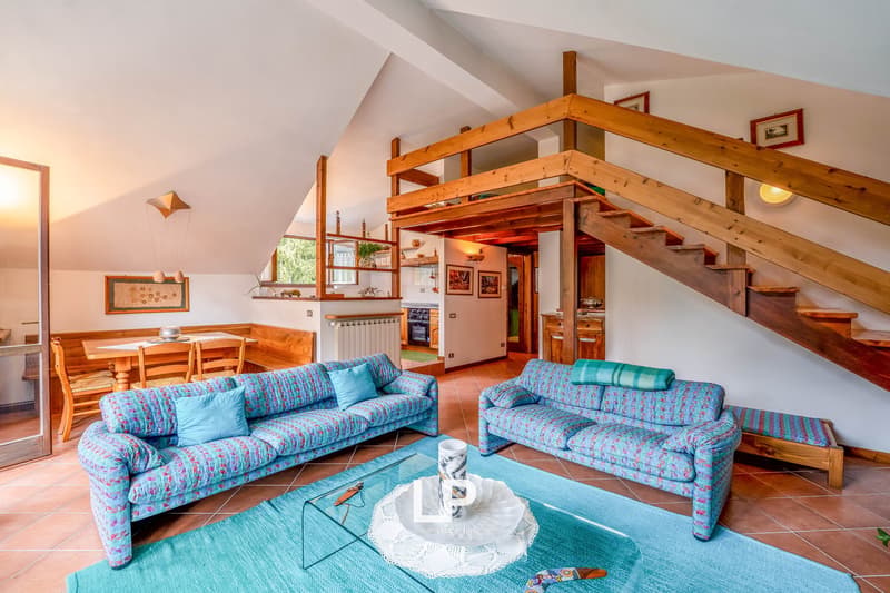 Blue couch, blue carpet, coffee table, stairs