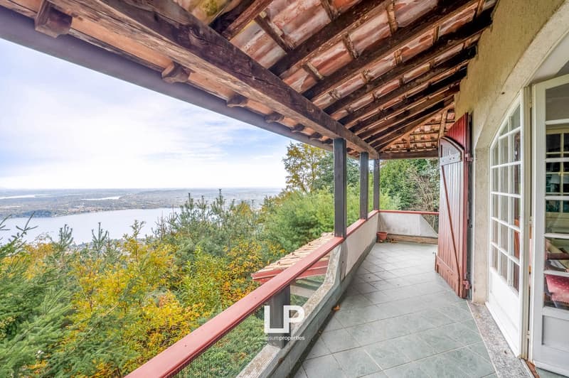 covered balcony with wooden beams, tiled floor, panoramic view of the lake and surrounding area