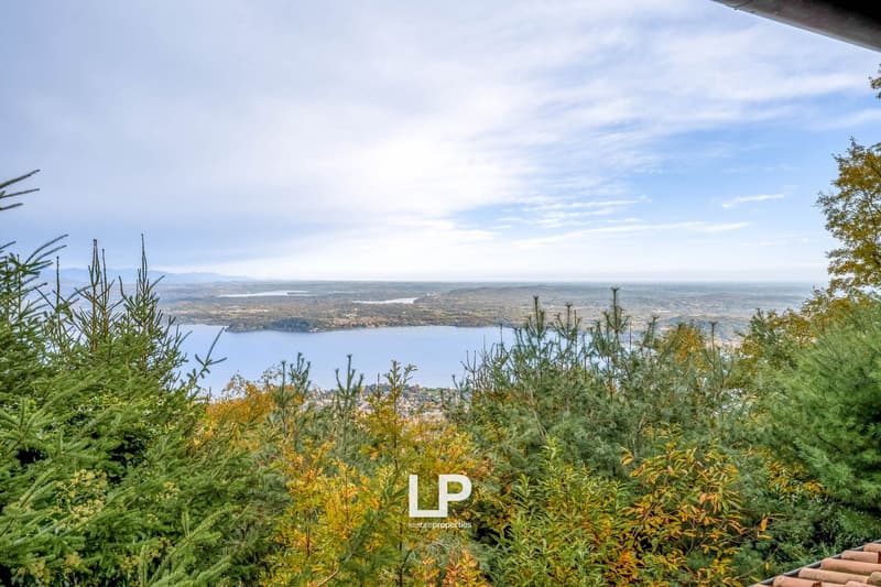 hilly landscape with a view of a large lake and a distant village