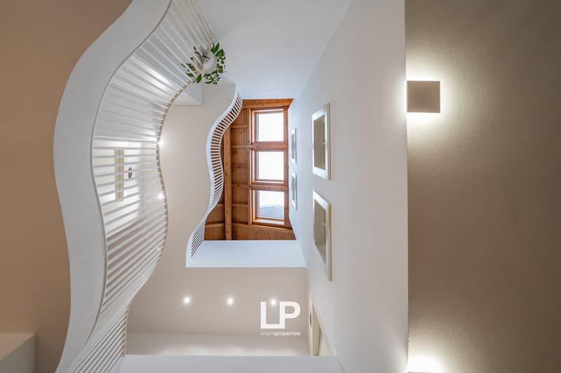 modern house, white walls, white railing, wooden roof, small window, white tiles