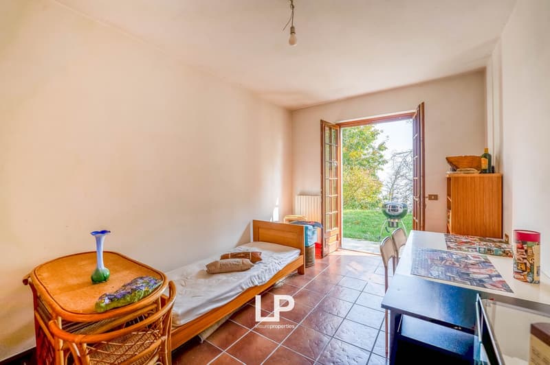 single bed, wicker table, desk, radiator, open terrace, chairs, tile floor