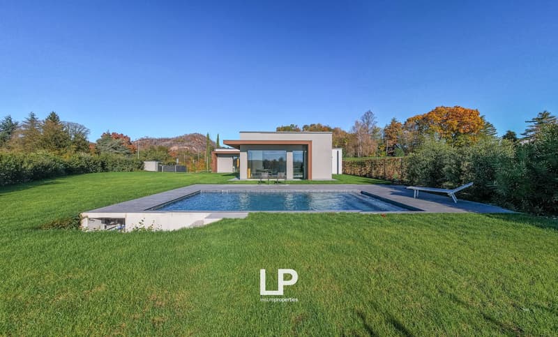modern style house, large windows, swimming pool, well-manicured lawn, glass fencing