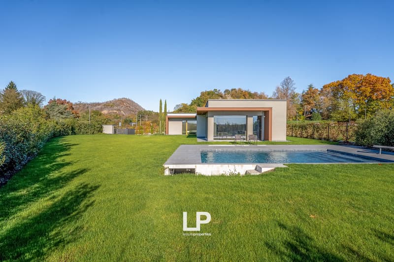 modern architecture house, large green lawn, swimming pool