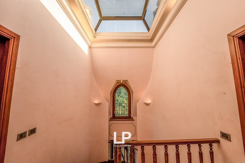 wooden handrail, pink walls, arch window, sky light