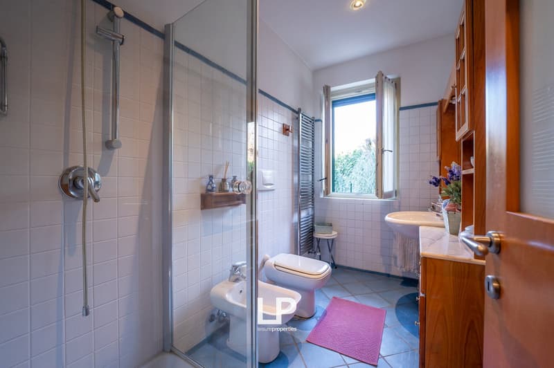 shower, sink, bidet, toilet, towel rack, window, floor