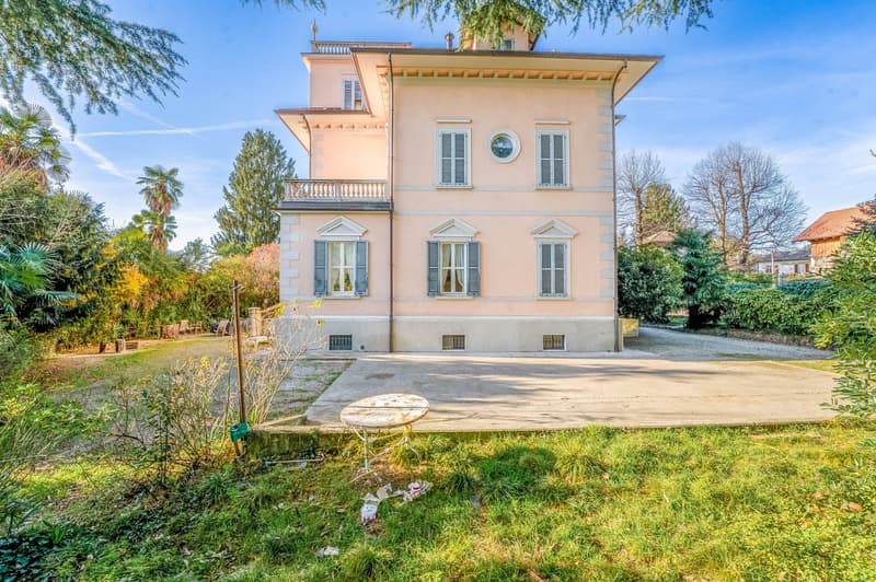 Large villa, pink facade, arched windows, raised ground floor, large driveway, garden