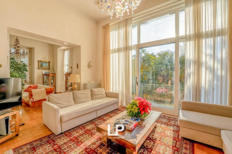 modern interior, carpet, 2 couches, center table, television, glass balcony