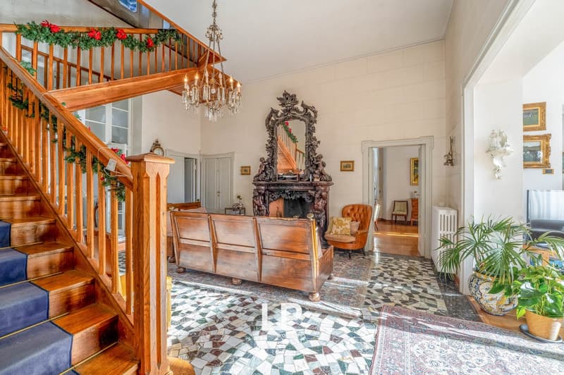 classic interior, staircase, chandelier, fireplace, vintage mirror, tiled floor, vintage furniture, potted plants