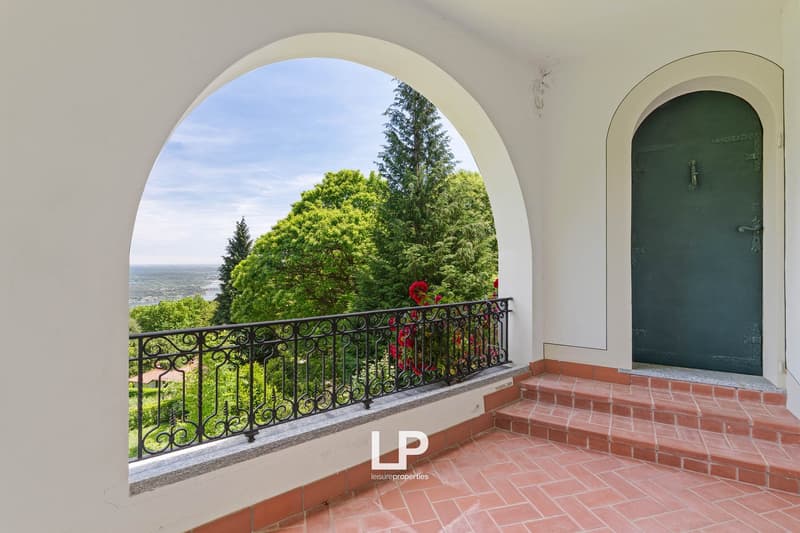 stone floor balcony, decorative railing, greenery view, brick steps