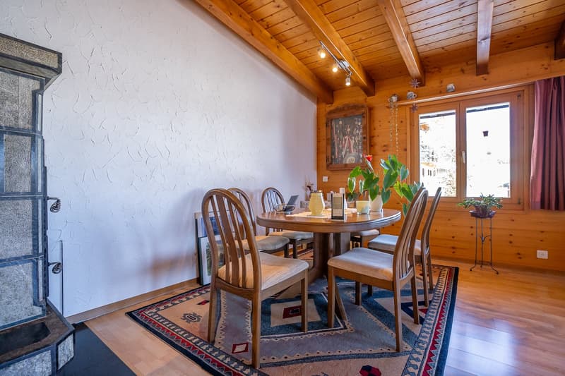 wooden walls, fireplace, round table, chairs, window, carpet, plants